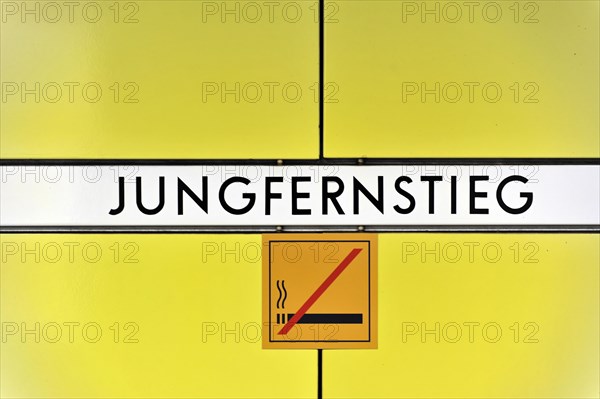 Sign of the underground station 'Jungfernstieg' with no smoking sign on yellow background, Hamburg, Hanseatic City of Hamburg, Germany, Europe