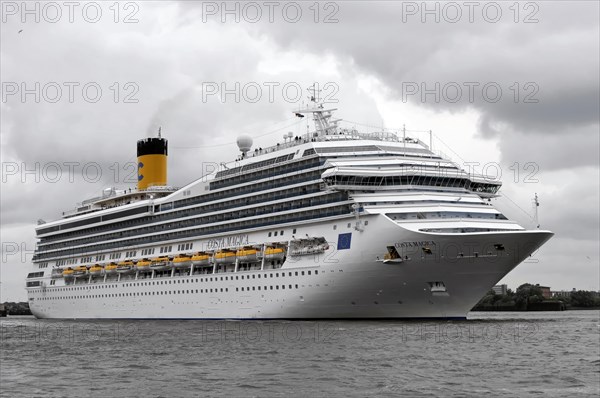 COSTA MAGICA, Large cruise ship with yellow smokestack on moving sea and grey sky, Hamburg, Hanseatic City of Hamburg, Germany, Europe