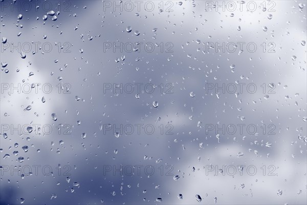 Raindrops on a window pane, North Rhine-Westphalia, Germany, Europe