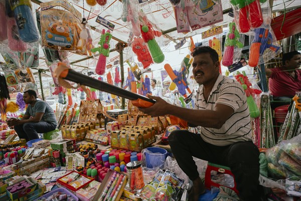 Vendor sells Holi celebration items in a street market, ahead of Holi festival on March 23, 2024 in Guwahati, Assam, India. Holi is the Hindu festival of colours, it is celebrated with great joy in India