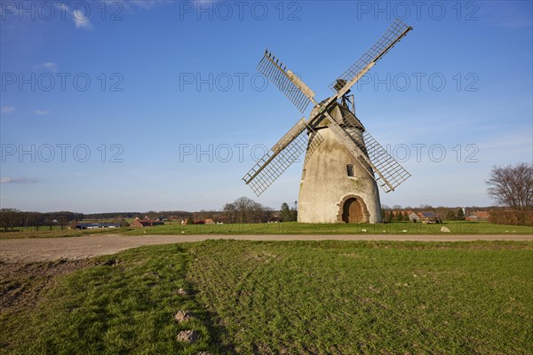 Windmill Auf der Hoechte under an almost cloudless blue sky is part of the Westphalian Mill Road in Hille, Muehlenkreis Minden-Luebbecke, North Rhine-Westphalia, Germany, Europe