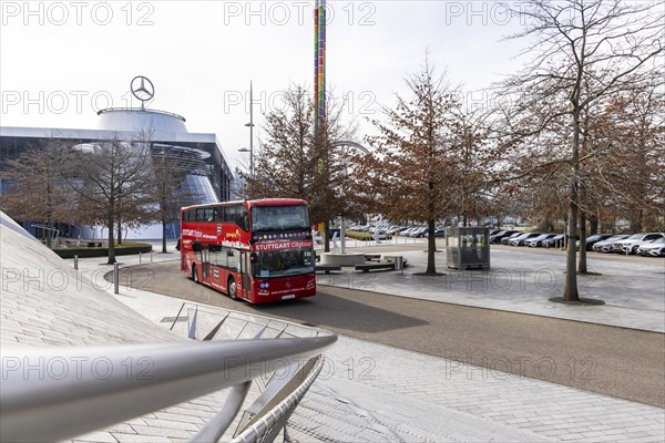 Stuttgrt Citytour. City tour in a red double-decker. City view of Stuttgart in front of the Mercedes Benz World in Bad Cannstatt, Stuttgart, Baden-Wuerttemberg, Germany, Europe