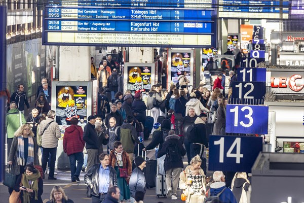 Central station, travellers in the platform hall. Extensive construction work on the railway network is communicated on the display board, Stuttgart, Baden-Wuerttemberg, Germany, Europe