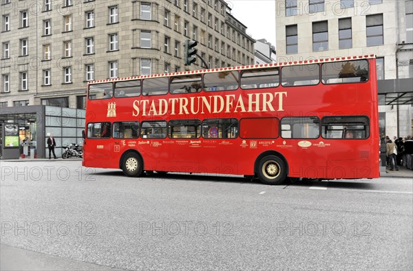 A red sightseeing double-decker bus travelling on a city street, Hamburg, Hanseatic City of Hamburg, Germany, Europe