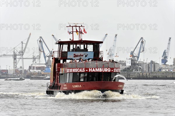 A red excursion boat sails on murky water in the harbour, Hamburg, Hanseatic City of Hamburg, Germany, Europe