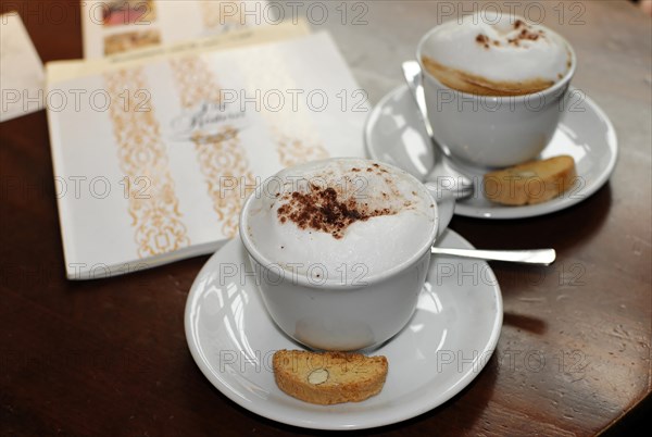 Two cups of cappuccino and espresso with pastries on a table in a cafe, Hamburg, Hanseatic City of Hamburg, Germany, Europe