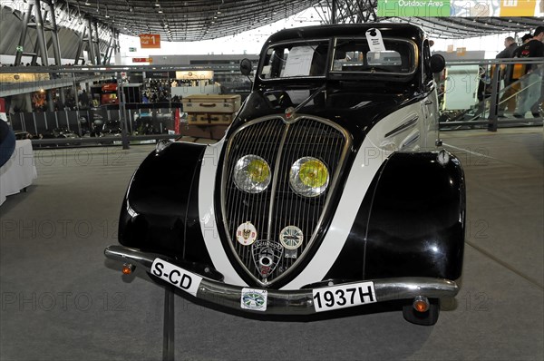 An elegant black vintage car from 1937 with chrome details and yellow headlights, Stuttgart Messe, Stuttgart, Baden-Wuerttemberg, Germany, Europe