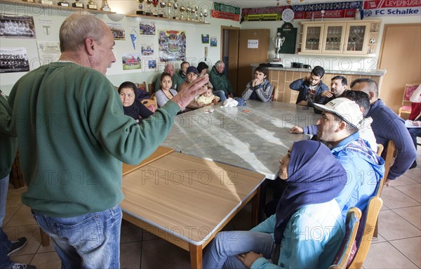 Syrian refugees learn traffic rules during an integration course. An employee of the Oberspreewald-Lausitz district and traffic watch organisation shows and explains traffic signs and rules to the refugees in the rooms of the Grossraeschen sports club, 05/10/2016