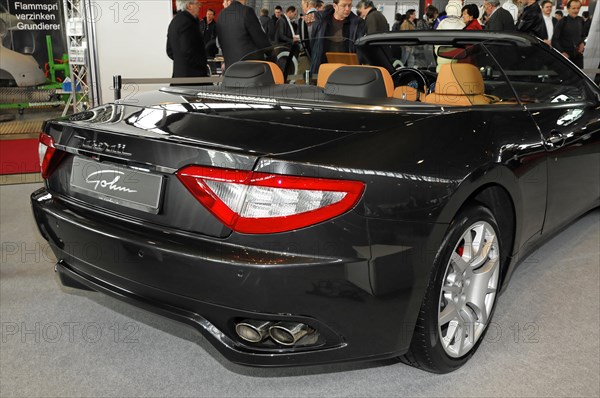 RETRO CLASSICS 2010, Stuttgart Messe, Stuttgart, Baden-Wuerttemberg, Germany, Europe, Maserati, Black convertible sports car at a car show with spectators in the background, Europe