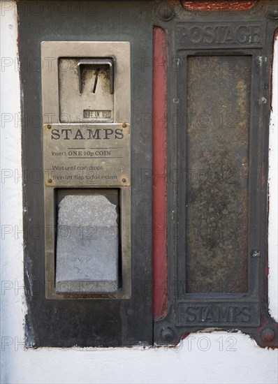 Old disused stamp vending machine and post box, England, UK