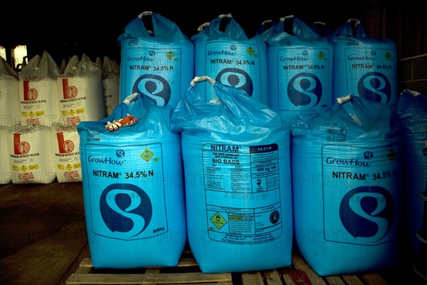 Blue Nitram fertiliser bags in a barn, England, UK