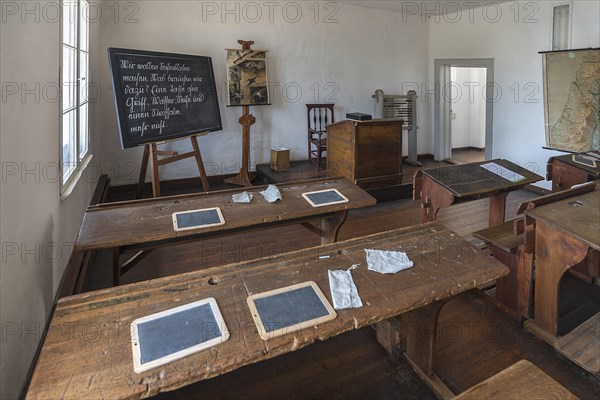 Chalkboards and blotting cloths on the school desks, blackboard and teacher's desk in a 19th century classroom, Open-Air Museum of Folklore Schwerin-Muess, Mecklenburg-Vorpommerm, Germany, Europe