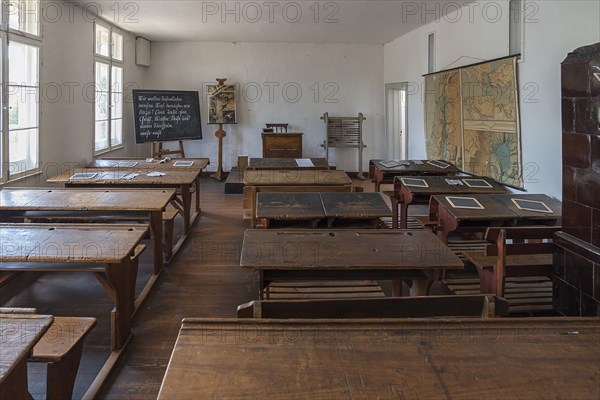 School desks, chalkboard and map, on the right a tiled stove in a classroom from the 19th century, Schwerin-Muess Open-Air Museum of Folklore, Mecklenburg-Western Pomerania, Germany, Europe