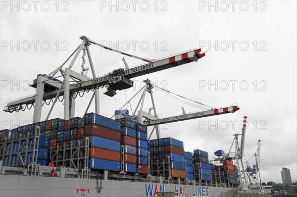 View of a container terminal with cranes and a loaded container ship, Hamburg, Hanseatic City of Hamburg, Germany, Europe