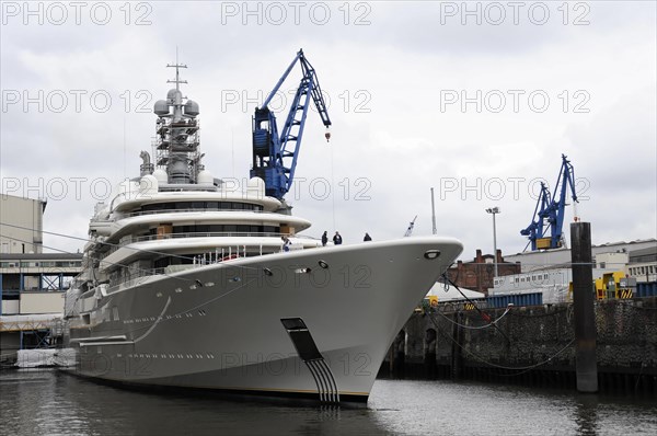 A large white luxury yacht moored in the harbour on a cloudy day, Hamburg, Hanseatic City of Hamburg, Germany, Europe
