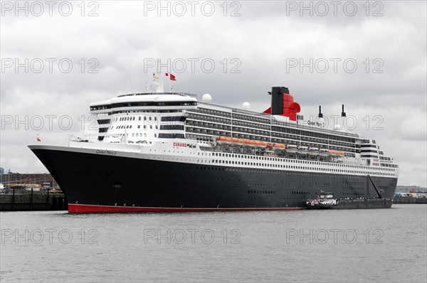 A large cruise ship Queen Mary 2, on the water with cloudy sky in the background, Hamburg, Hanseatic City of Hamburg, Germany, Europe