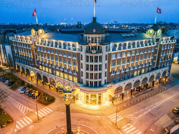 Aerial view of the Stoertebeker House at blue hour with granite column and ship, which is a replica of Stoertebeker's cog, Hamburg, Germany, Europe