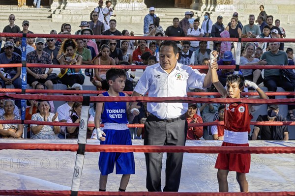 Oaxaca, Mexico, The referee declares the winner in a youth boxing match in the zocalo, Central America