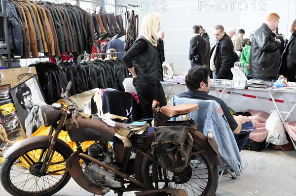 Flea market stand with vintage motorbike, clothes and people in the background, Stuttgart Messe, Stuttgart, Baden-Wuerttemberg, Germany, RETRO CLASSICS 2010, Europe