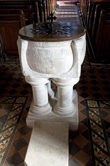 Carved limestone stonework baptismal font, All Saints church, Sudbourne, Suffolk, England, United Kingdom, Europe