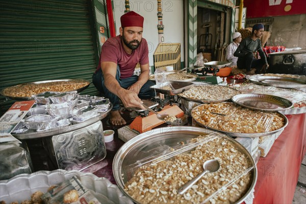 People buy food at a stall to break their fast during the holy month of Ramadan, on March 15, 2024 in Guwahati, Assam, India, Asia