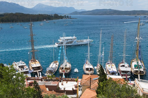 The view of a tranquil harbour with numerous sailing boats and yachts, surrounded by hills and nature, Poros, Poros Island, Saronic Islands, Peloponnese, Greece, Europe