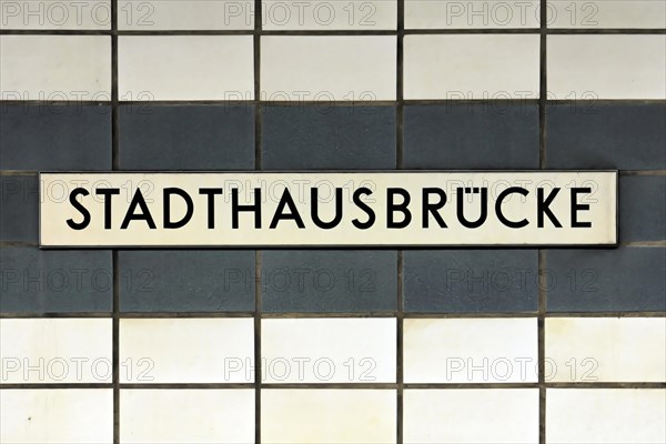 A sign with the inscription Stadthausbruecke on a wall with blue tiles, Hamburg, Hanseatic City of Hamburg, Germany, Europe