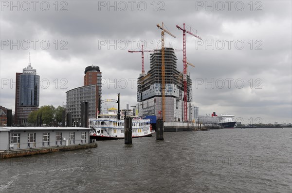 A cruise ship Queen Mary 2, in the harbour next to a construction site and skyscrapers in overcast weather, Hamburg, Hanseatic City of Hamburg, Germany, Europe