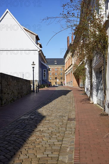 Alley Martinikirchhof with cobblestones and lantern in the city centre of Minden, Muehlenkreis Minden-Luebbecke, North Rhine-Westphalia, Germany, Europe