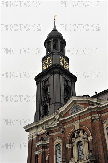 Michaeliskirche, Michel, baroque church St. Michaelis, first start of construction 1647- 1750, The tower of a historic building with clocks and overcast sky in the background, Hamburg, Hanseatic City of Hamburg, Germany, Europe