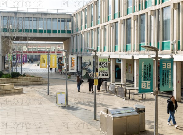 Students walking in campus square area, University of Essex, Colchester, Essex, England, UK