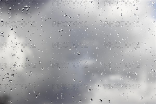 Raindrops on a window pane, North Rhine-Westphalia, Germany, Europe