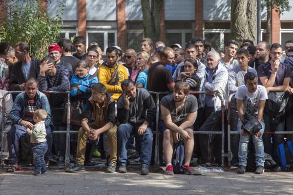 Refugees from Syria wait behind barriers in the central reception centre for asylum seekers at the State Office for Health and Social Affairs in Berlin, 26/08/2015