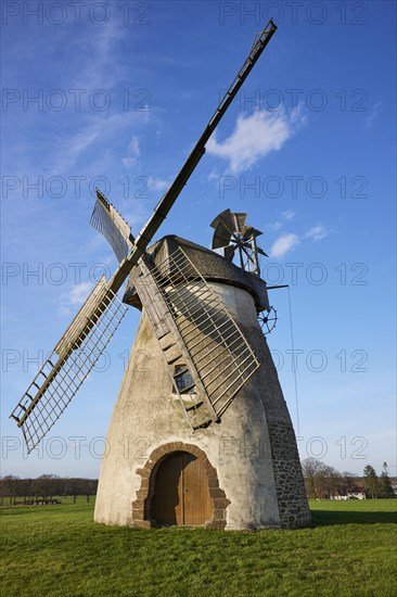 Windmill Auf der Hoechte with blue sky and small white clouds in Hille, Muehlenkreis Minden-Luebbecke, North Rhine-Westphalia, Germany, Europe