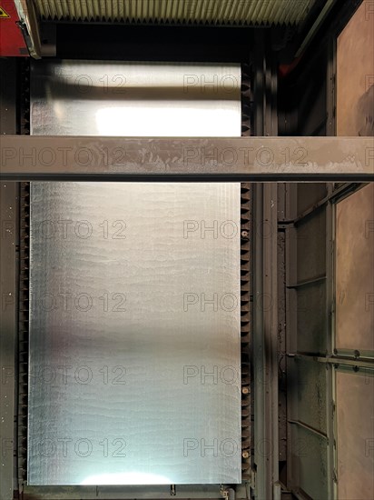 Top view of a table with a steel sheet being cut on a metal laser cutting machine