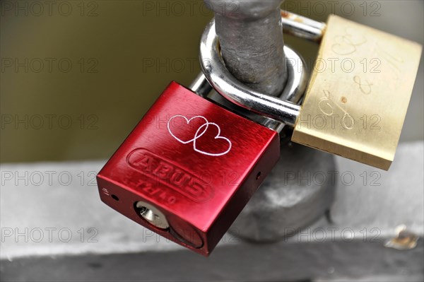 A rusty red love lock with a heart-shaped dovetail on a railing, Hamburg, Hanseatic City of Hamburg, Germany, Europe