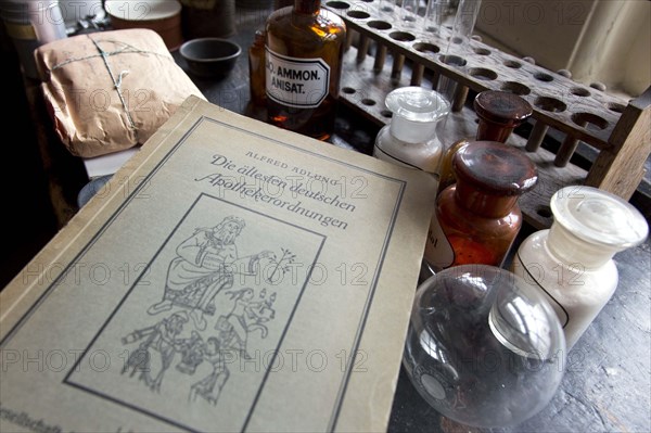An old book on German pharmacy regulations lies on a worktable in the former laboratory of the historic Berg-Apotheke pharmacy in Clausthal-Zellerfeld. The current Berg-Apotheke, one of the oldest pharmacies in Germany, was built in 1674, 09 November 2015