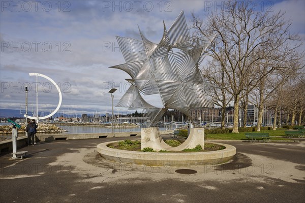 Art object Ouverture au Monde by artist Angel Duarte and the large, semi-circular wind vane Eole, a sculpture by artist Clelia Bettua, in Lake Geneva within the Ouchy harbour in the Ouchy district, Lausanne, district of Lausanne, Vaud, Switzerland, Europe