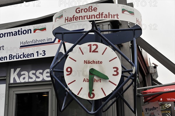 A large clock shows the time for the next harbour tour, surrounded by information, Hamburg, Hanseatic City of Hamburg, Germany, Europe