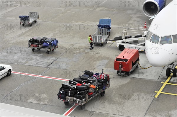 Luggage being loaded onto an aeroplane on an airport tarmac, Hamburg, Hanseatic City of Hamburg, Germany, Europe