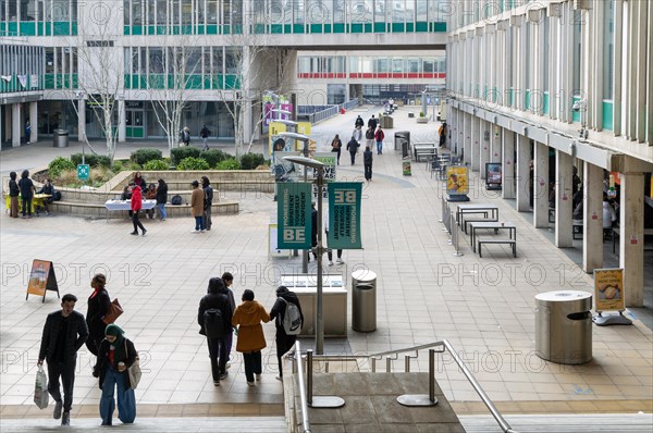 Students walking in campus square area, University of Essex, Colchester, Essex, England, UK