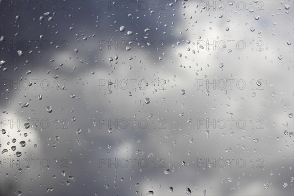 Raindrops on a window pane, North Rhine-Westphalia, Germany, Europe