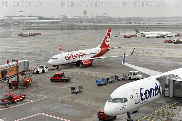 Two aeroplanes on the tarmac with airport vehicles, Hamburg, Hanseatic City of Hamburg, Germany, Europe