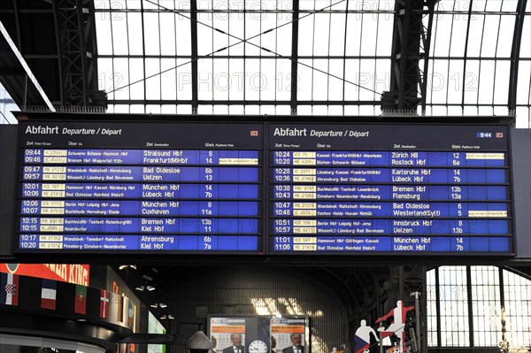 A digital departure board shows the next train connections at a railway station, Hamburg, Hanseatic City of Hamburg, Germany, Europe