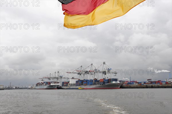View of a busy container harbour with a waving German flag, Hamburg, Hanseatic City of Hamburg, Germany, Europe