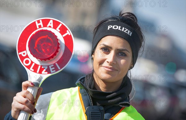 Policewoman of the Berlin police with police trowel during a traffic control, 20/03/2015