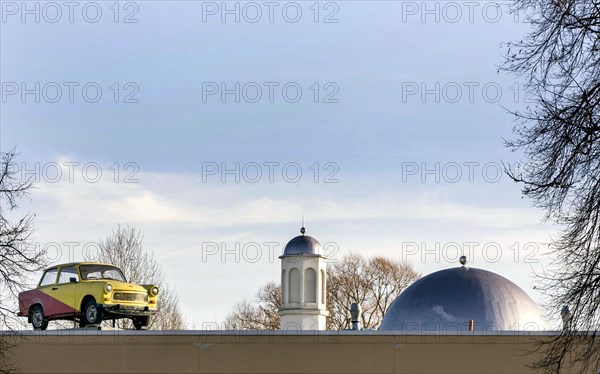 A Trabant on the roof of a workshop, in the background you can see the Khadija Mosque in the Berlin district of Pankow, 10 December 2015