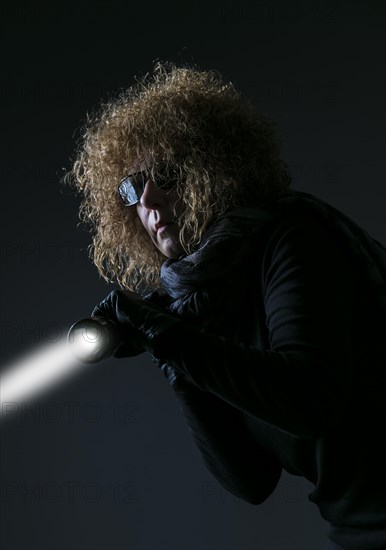 Studio shot, woman in sharp clothing with torch, Berlin, Germany, Europe