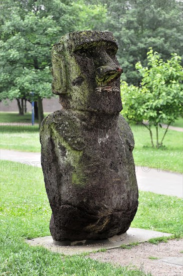 A moss-covered stone sculpture, similar to the Moai from Easter Island, in the park, Hamburg, Hanseatic City of Hamburg, Germany, Europe