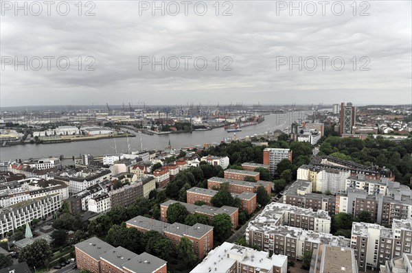View of a city on a cloudy day with river and harbour facilities in the background, Hamburg, Hanseatic City of Hamburg, Germany, Europe